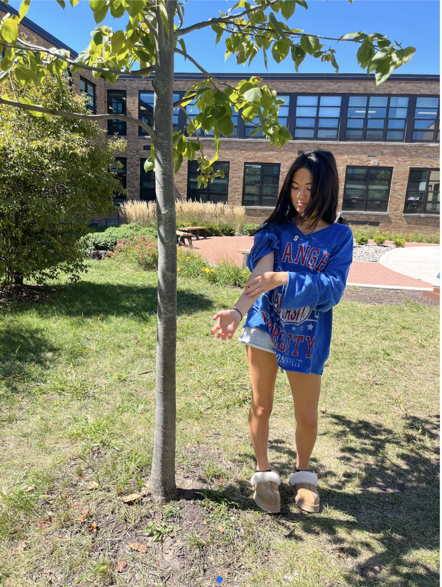 Sofia Nucifora, junior, itching her mite bite in the courtyard.
